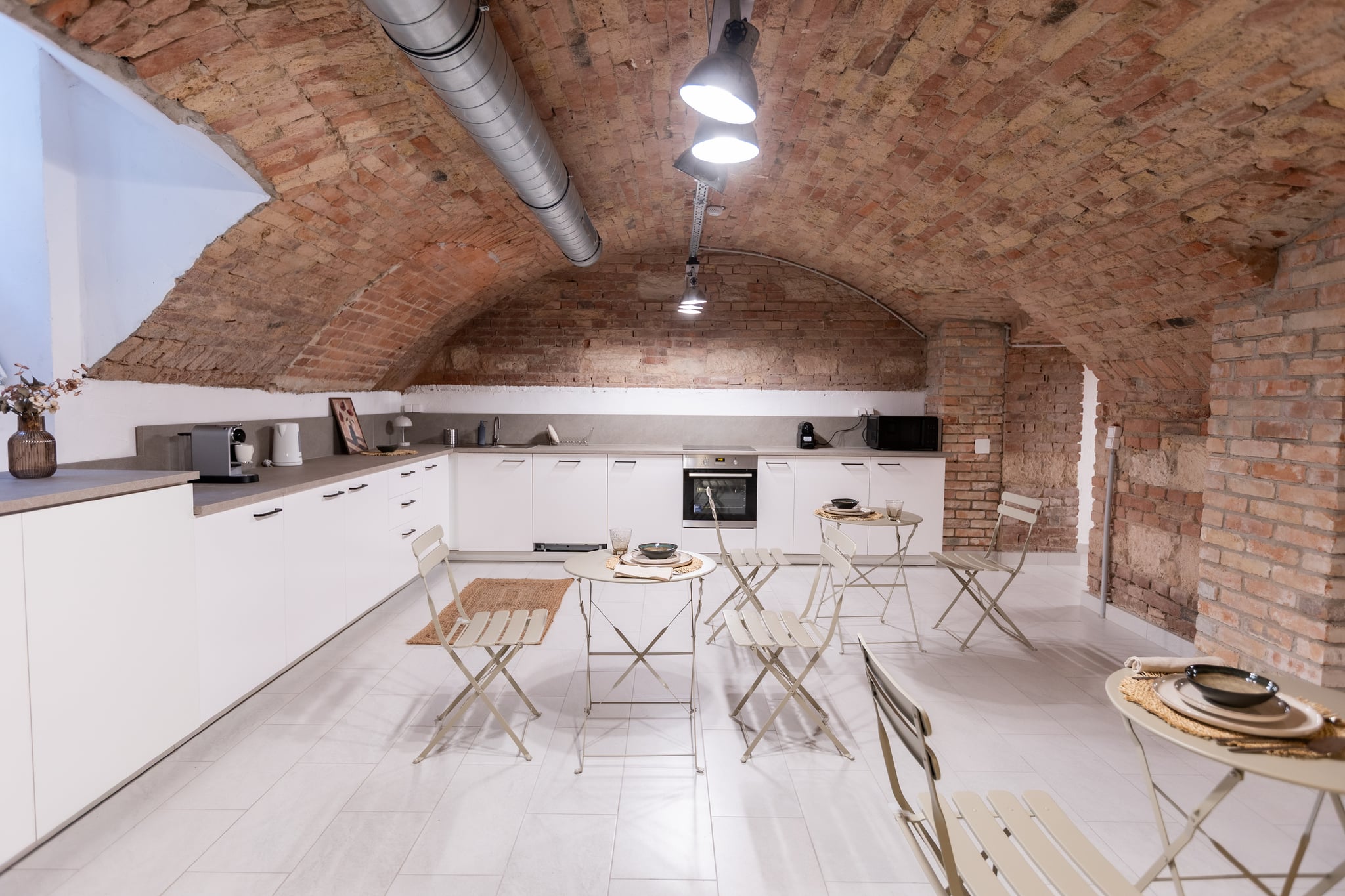 The shared kitchen and dining area under the brick vaulting